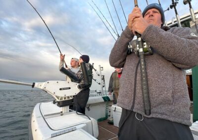 Two men fishing on back of charter fishing boat