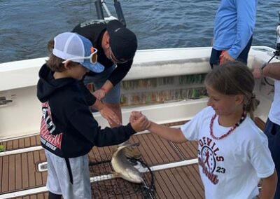 Fishing on back of charter fishing boat